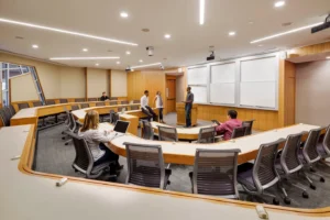 A large conference room with people standing around it.