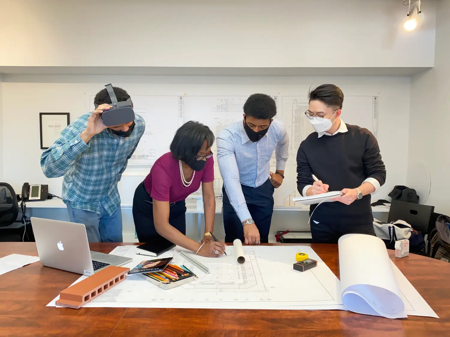 A group of people standing around a table.