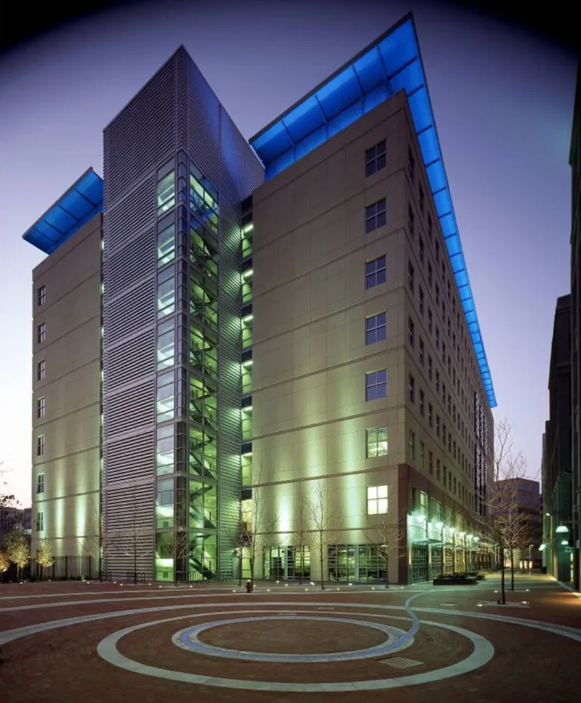 A large building with blue lights on the top of it.