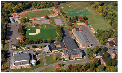 An aerial view of a school with baseball fields and a field.